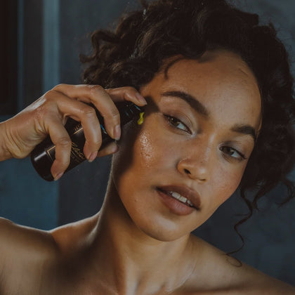 photo of beautiful woman applying alitura gold serum