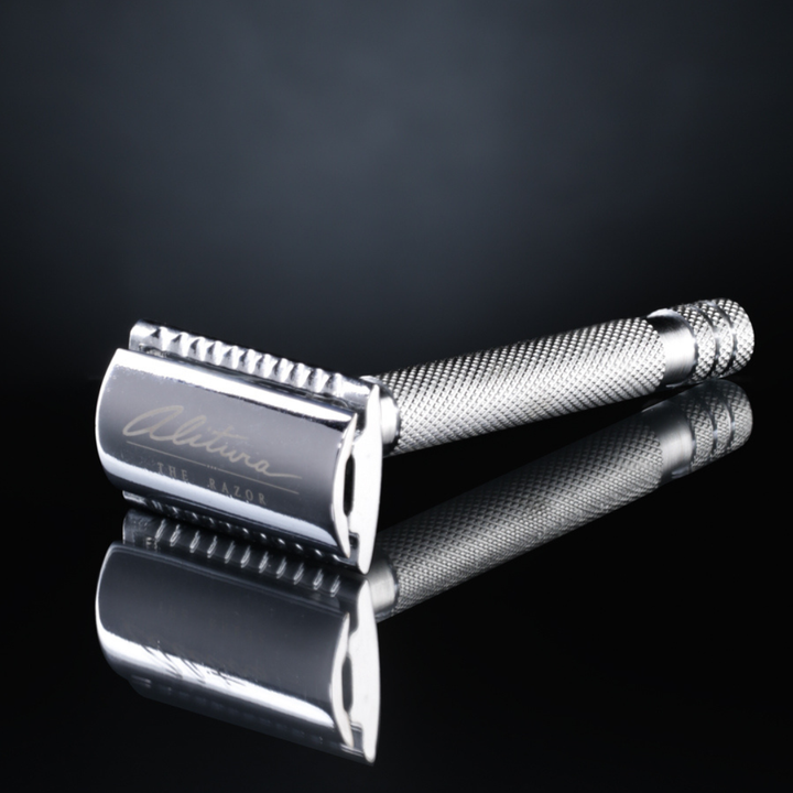 Silver safety razor on a black background