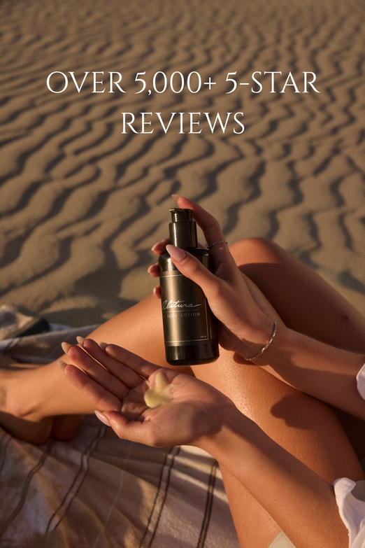 Person holding a bottle of cologne with sand in the background and text about reviews.