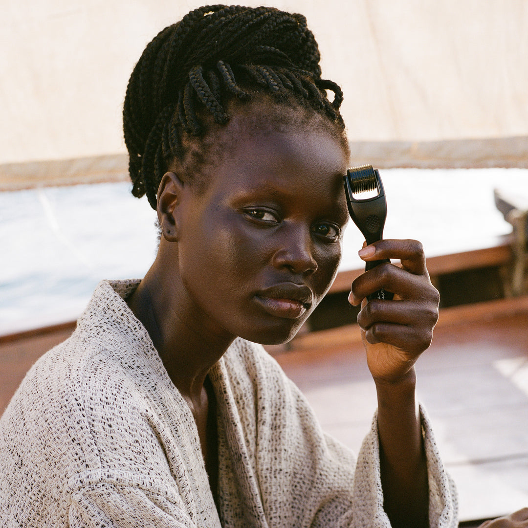 Woman holding a dermaroller with a blurred background